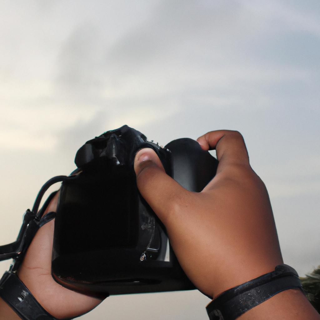 Person holding camera, capturing image